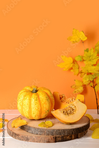 Board with fresh pumpkins a...