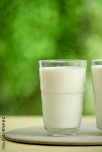 Glass of fresh milk on yell...