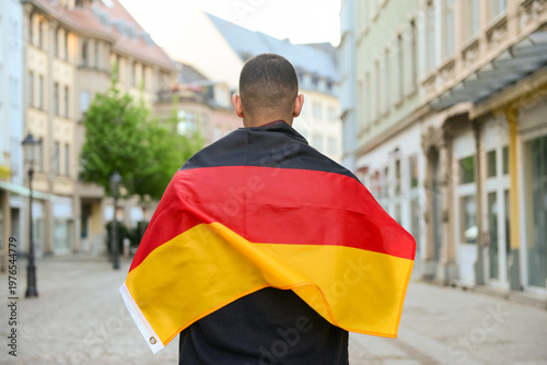 Young man with flag of Germ...