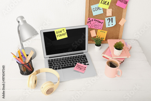 Laptop with sticky notes, h...