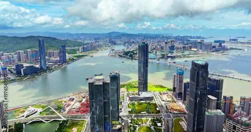 Drone view of Zhuhai modern skyscrapers and Macau city skyline across the water, China