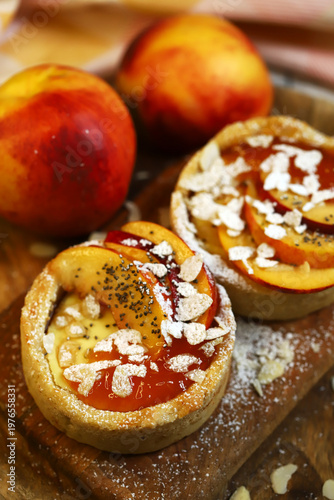 Peach cheesecake with powdered sugar and almonds