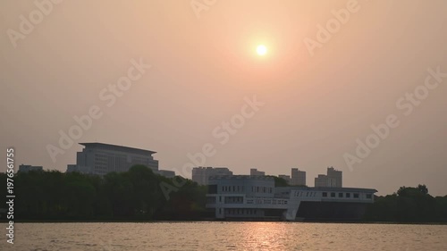Urban Riverbank Video: Panoramic View of Flowing Clouds and Waterfront Skyline at Dawn and Dusk