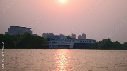 Urban Riverbank Video: Panoramic View of Flowing Clouds and Waterfront Skyline at Dawn and Dusk