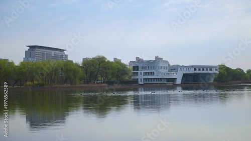 Urban Riverbank Video: Panoramic View of Flowing Clouds and Waterfront Skyline at Dawn and Dusk