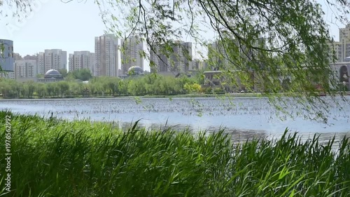 Urban Riverbank Video: Panoramic View of Flowing Clouds and Waterfront Skyline at Dawn and Dusk