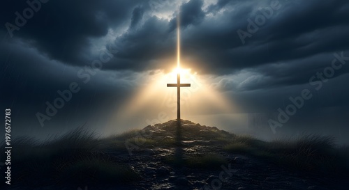 Dramatic cross on top of hill with charming sunlight.