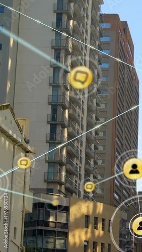 Vertical video: Upward tilt sparking AR overlay over tower, yellow nodes forming blue web for tech