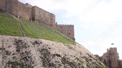 massive stone glacis and defensive walls of the Citadel of Aleppo, Syria. Iconic medieval fortress architecture and historical military fortification