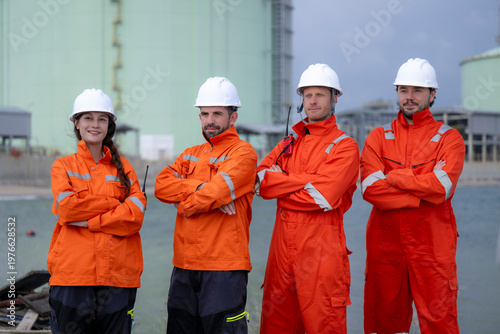 Industrial workers team posing in a refinery plant