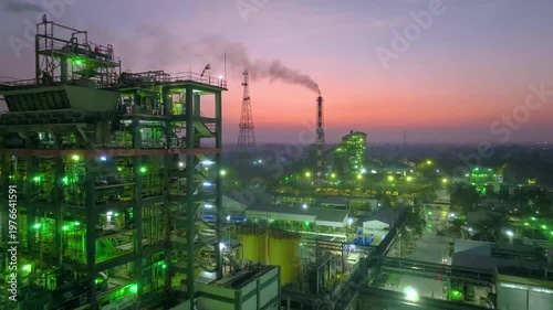 Drone shot of industrial factory at night with glowing lights in Nagda India