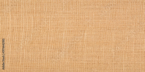 A vintage brown paper texture background with a rough natural fiber pattern featuring a blank beige canvas material and a woven burlap textile design