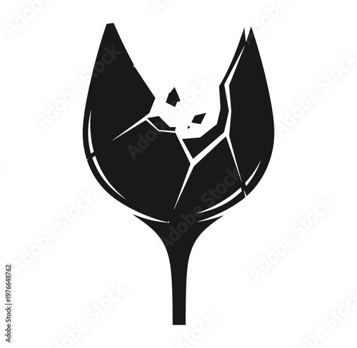Black silhouette of a flower or tulip with broken petals and stem on white background