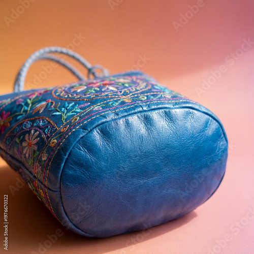 close-up of a vibrant blue bag with intricate stitching and a subtle sheen place