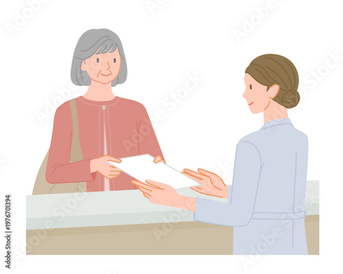 Senior woman handing document to female staff at hospital reception