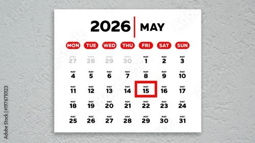 The date May 15th marked with a red cursor on a wall calendar 2026