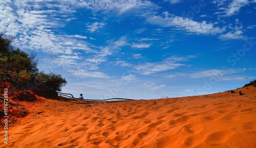 Cape Peron National Park Western Australia a solitary figure on red sand dunes blue sky