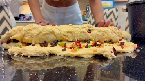 The process of kneading dough with candied fruit for Easter cake