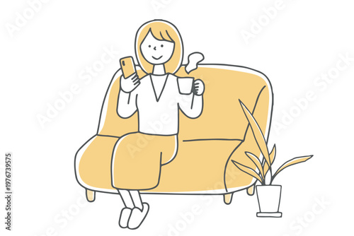 ソファで温かい飲み物を飲みながらスマホを見る女性単色