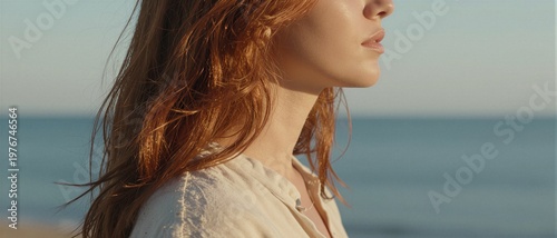 Natural redhead woman looking at the sea, wellness and mindfulness concept on summer beach
