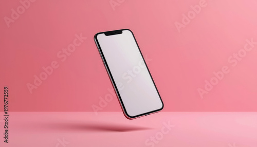 A sleek smartphone with a blank screen floating in mid-air against a vibrant pink background
