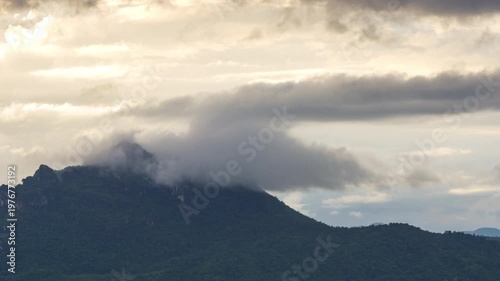 4K video of an aerial view of beautiful clouds or fog moving over the mountain peaks in northern Thailand.