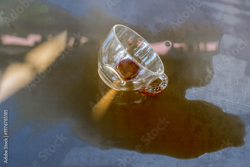 The coffee cup was spilled and scattered.