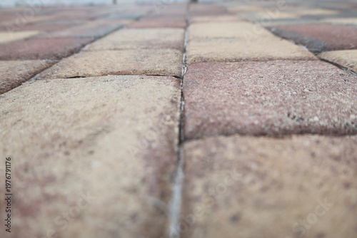 Low angle shot of brick pavement with repeating pattern and texture. Outdoor ground surface concept.