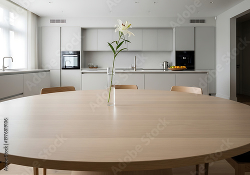 A large wooden table in a kitchen with a vase of flowers on it