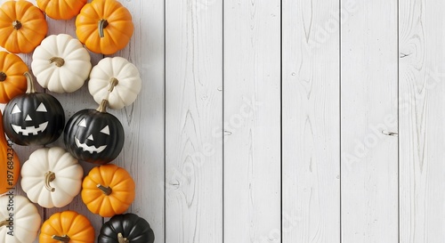 Autumn mini pumpkins and jack-o'-lanterns on rustic white wooden background