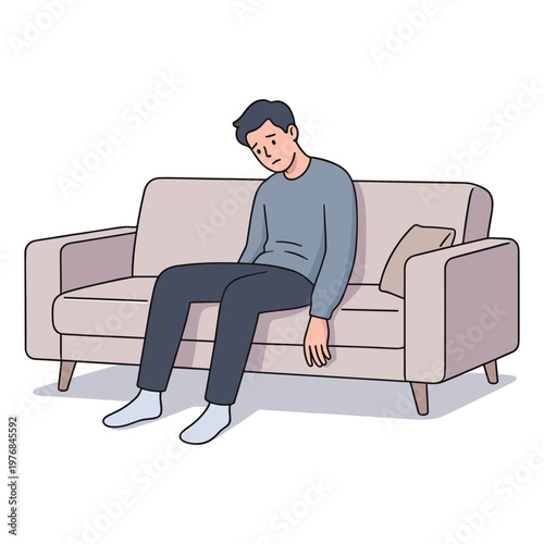 A man sits on a couch looking sad and depressed