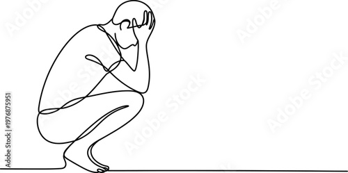 Person sitting on floor with head in hands looking sad