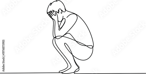 Person sitting on ground with head in hands looking sad