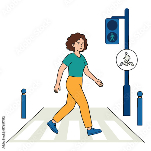 A woman crosses the street at a pedestrian crossing with a traffic light.