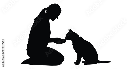 Woman kneeling and feeding cat from a bowl on the floor