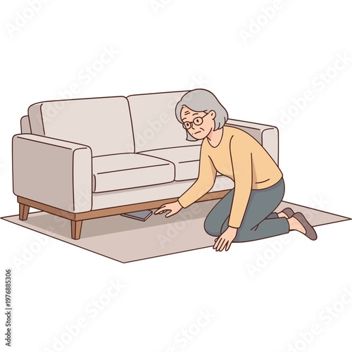Elderly woman kneels to pick something up from under the couch