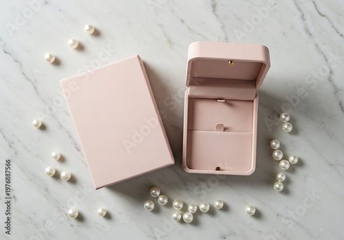 Pink jewelry box open with pearls on marble surface for elegant presentation