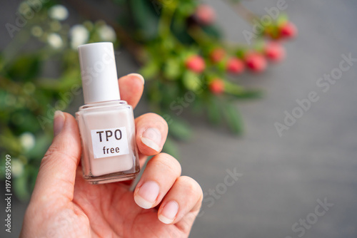 TPO free gel nail polish lying on a table in soft natural light. Highlighting clean beauty choices and awareness of Trimethylbenzoyl Diphenylphosphine Oxide in cosmetics