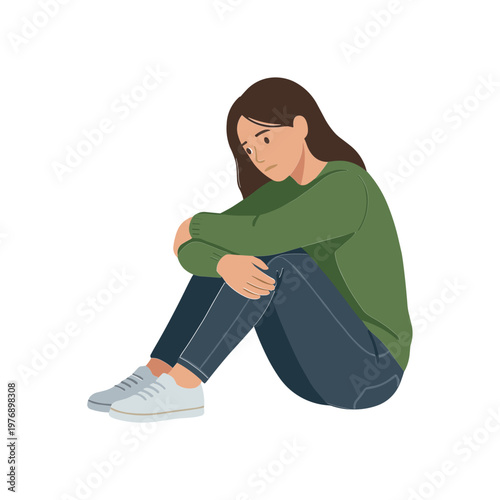 A woman sits alone on the ground with her arms crossed