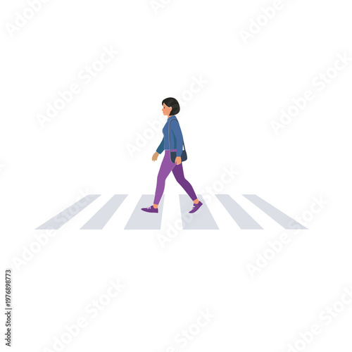 A person walks across a crosswalk on the street alone