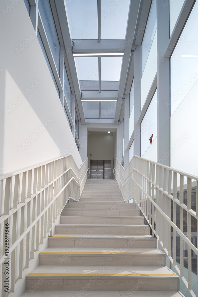 Obraz premium Stair bridge in glass atrium with skylight above contemporary building