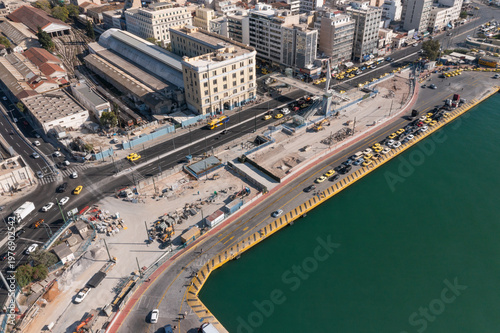 Top-down view of Piraeus waterfront promenade with coastal buildings and turquoise sea