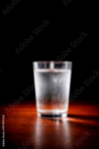 Glass of Water on Bar Counter in Nightlife Setting. Blurred background, copy space