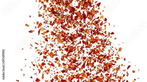 Red chili pepper flakes falling and scattering in an isolated studio shot with white background