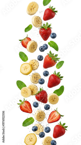 Fresh isolated strawberries blueberries banana slices and mint leaves falling