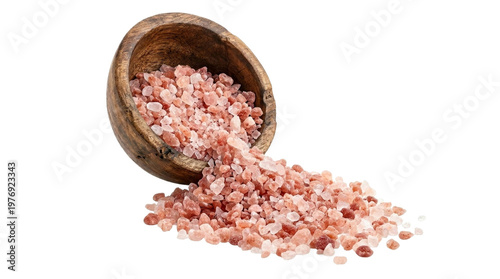 Isolated pink salt pouring from wooden bowl on white