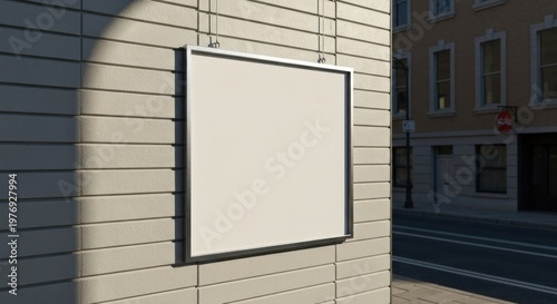 Blank square sign hangs on brick wall; urban background