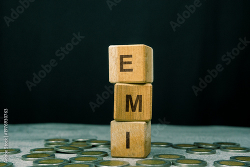 EMI word on a stack of wooden cubes. Financial Investment Concept