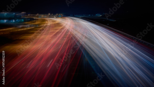 Highway light trails at night, speed and data flow technology concept