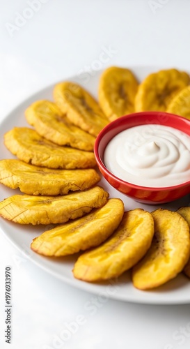 Fried Plantains with White Sauce on White Plate